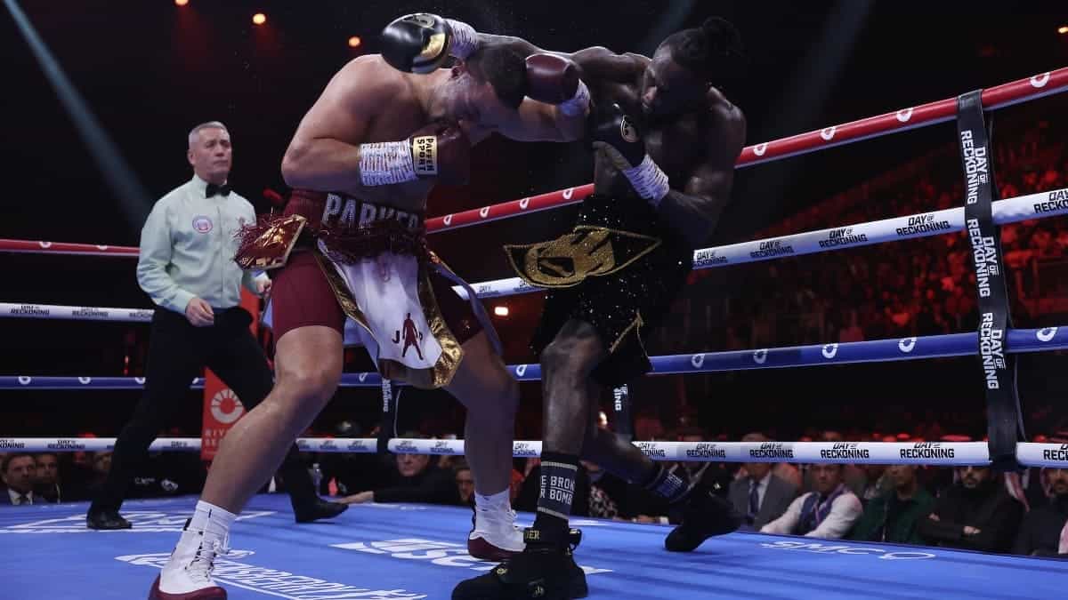 Deontay Wilder throws a punch at Joseph Parker